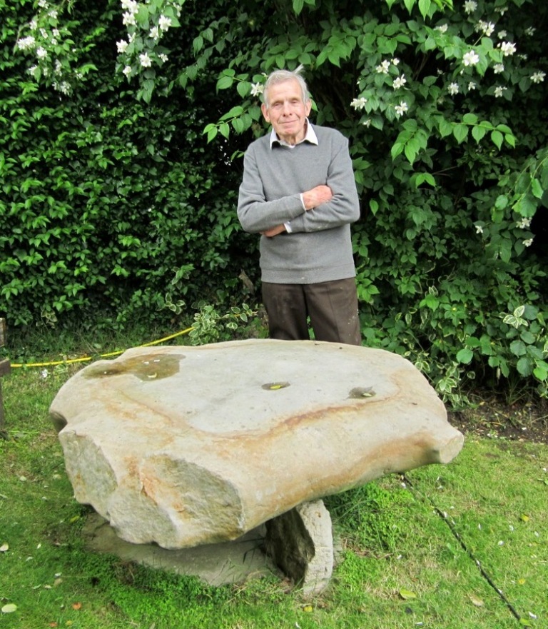 Bob Burton in his garden with a giant sarsen stone as an outdoor table. Photograph: Graham Ward