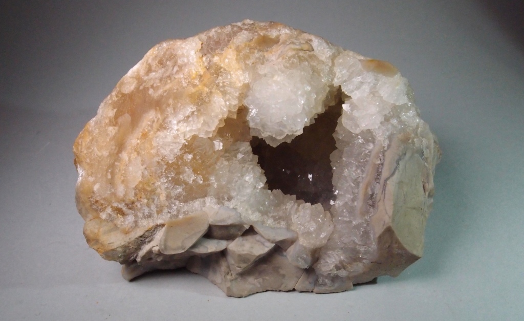 A white flint with a milky chalcedony centre containing a cavity lined with medium-sized translucent sparkling quartz crystals.  A very attractive 'geode'. From Church Lane Gravel Pit, Stanway, Essex.  Bob Burton Collection. Photograph: Gerald Lucy